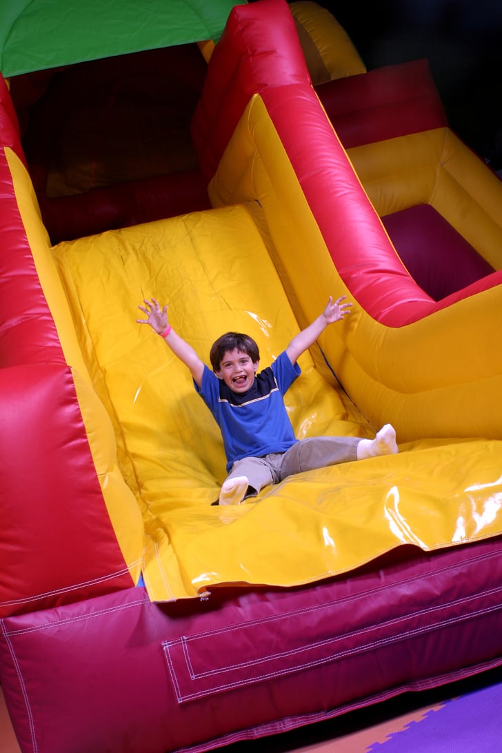 Boy on inflatable slide goes fast