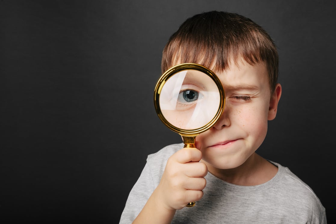 Child See through Magnifying Glass on the Black Backgrounds.